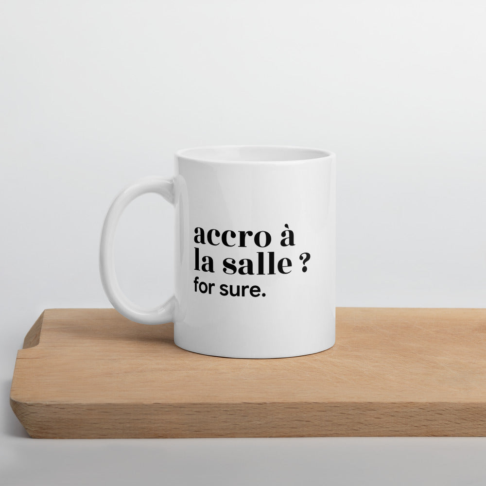 Mug blanc « accro à la salle ? for sure. », sur une planche en bois